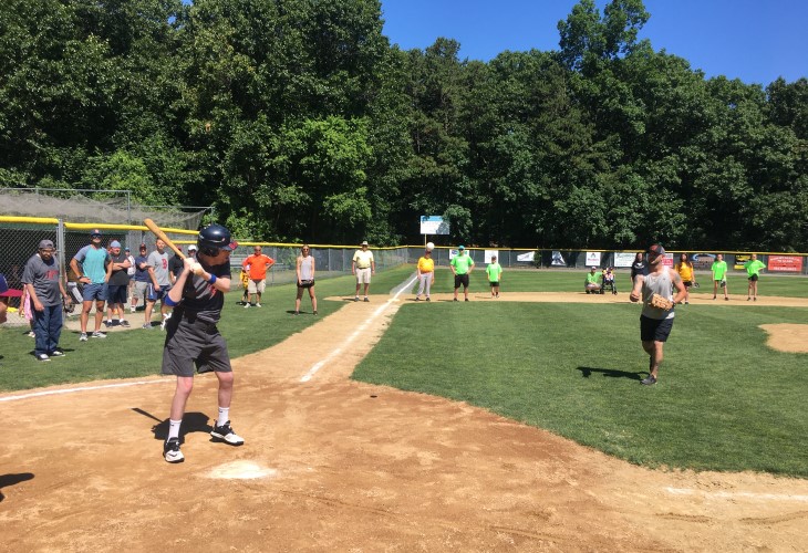 Johnny at bat on a sunny baseball diamond.